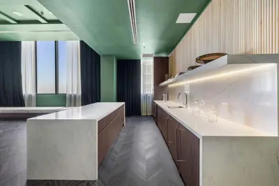 a large kitchen with a white counter and green ceilings at Central Downtown Condo with Pool & Gym in Miami