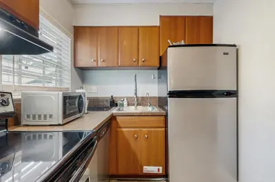 a kitchen with a refrigerator and a microwave at The Palms in Fort Lauderdale