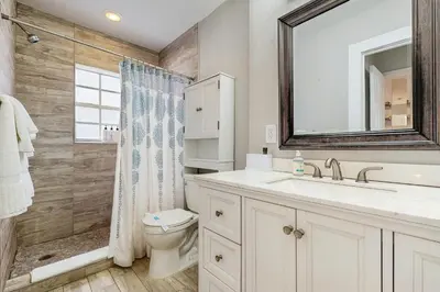a bathroom with a sink and a toilet and a mirror at The Palms in Fort Lauderdale