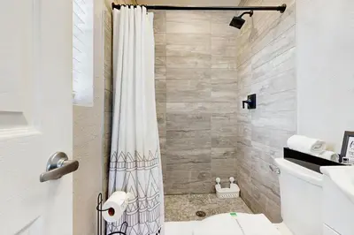 a bathroom with a shower curtain and a toilet at The Palms A in Fort Lauderdale