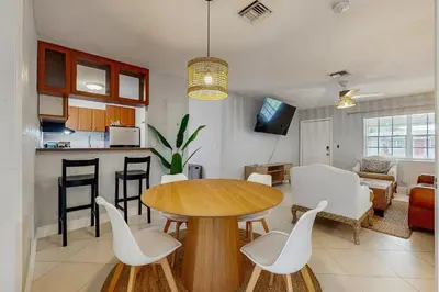 a kitchen and living room with a table and chairs at The Palms B in Fort Lauderdale