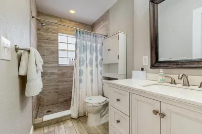 a bathroom with a toilet and a sink and a shower at The Palms B in Fort Lauderdale