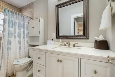 a bathroom with a sink and a toilet and a mirror at The Palms B in Fort Lauderdale
