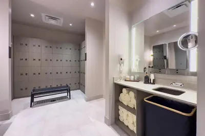 a bathroom with a sink and a bench in a room at 3512 Elegant Studio in Miami Downtown with a Pool and a 24-7 Gym in Miami