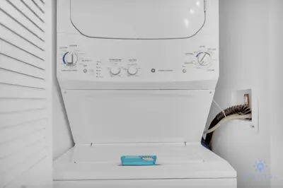 a white washing machine in a white room at Spectacular Near Beach 2 BR Apartment in Hallandale Beach