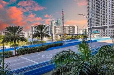 a parking lot in a city with palm trees and buildings at Great views Apartment with Pool & Balcony in Hallandale Beach
