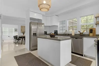 a kitchen with white walls and stainless steel appliances at 7BD Downtown Oasis - Pool - 10 Mins to South Beach in Miami