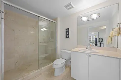 a bathroom with a shower and a toilet and a sink at Spacious 3BR Condo Across from Beach with Ocean & City Views in Sunny Isles Beach