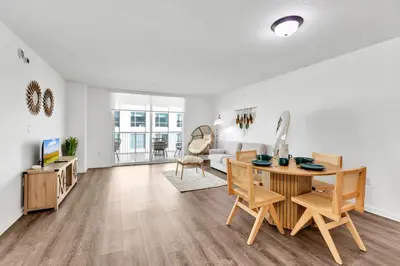 a living room with a table and chairs and a couch at Upscale4 Brickell Retreat with Bay n City Views in Miami
