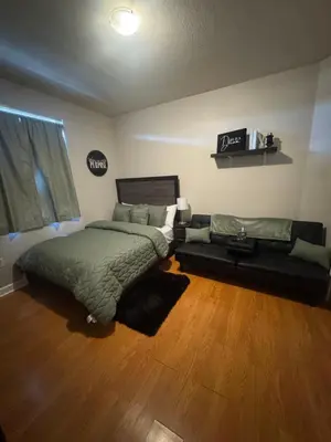 a bedroom with a bed and a couch at The B Shared Resident in Miramar