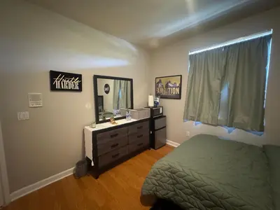 a bedroom with a bed and a dresser and a mirror at The B Shared Resident in Miramar