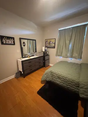 a bedroom with a bed and a mirror and a dresser at The B Shared Resident in Miramar
