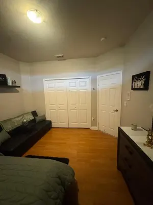 a living room with two white doors and a couch at The B Shared Resident in Miramar