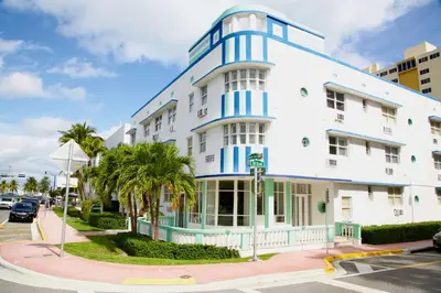 a white building with blue accents on a street at Cozy3 Miami Beach Getaway Quick Walk to the Ocean in Miami Beach