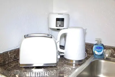 two toasters sitting on a kitchen counter next to a sink at Cozy3 Miami Beach Getaway Quick Walk to the Ocean in Miami Beach