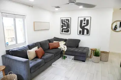 a living room with a blue couch and a table at Pool House in Fort Lauderdale in Fort Lauderdale