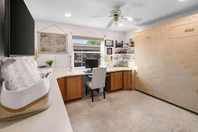 a kitchen with a desk with a computer in it at Plantation Pool Home with Hot Tub Sleeps 10 in Plantation