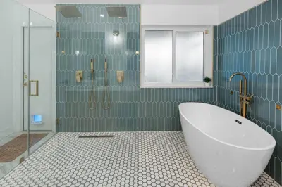 a bathroom with a tub and a glass shower at Plantation Pool Home with Hot Tub Sleeps 10 in Plantation