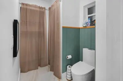 a bathroom with a toilet and a shower at Plantation Pool Home with Hot Tub Sleeps 10 in Plantation