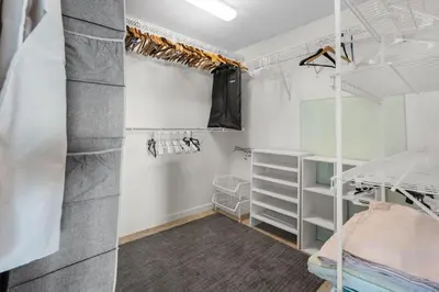 a bedroom with white walls and white bunk beds at Plantation Pool Home with Hot Tub Sleeps 10 in Plantation