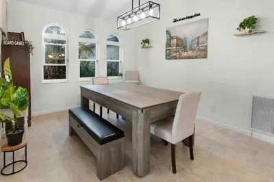 a dining room with a wooden table and chairs at Plantation Pool Home with Hot Tub Sleeps 10 in Plantation