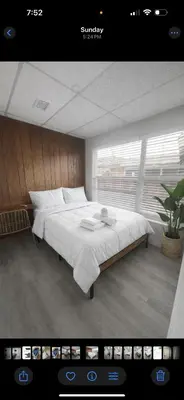 a bedroom with a large white bed in a room at Santorini Hollywood in Hollywood