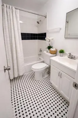 a white bathroom with a toilet and a sink at Santorini Hollywood in Hollywood