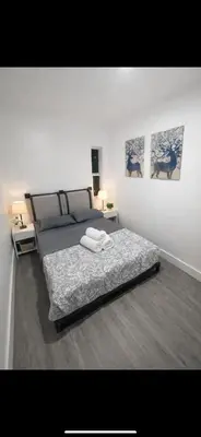 a bedroom with a bed and two pictures on the wall at Santorini Hollywood in Hollywood