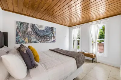 a bedroom with a large bed with a wooden ceiling at Spacious Miami Home with Private Pool & Parking in Biscayne Park