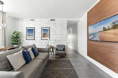 a living room with a couch and a large painting on the wall at Miami Beach 2Q Localização Incrível a Pé da Praia in Miami Beach