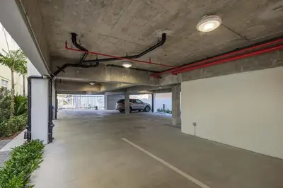 a parking garage with a car parked in it at Apto 2 Quartos c/ Varanda South Beach Central in Miami Beach