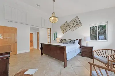 a bedroom with a bed and a desk and a table at Oceanfront Luxury Villa 5Bedroom and 4Bath Beach Access in Hollywood