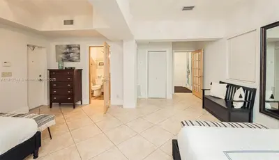 a large room with two beds and a dresser at Oceanfront Luxury Villa 5Bedroom and 4Bath Beach Access in Hollywood