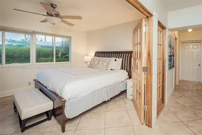 a bedroom with a bed with a ceiling fan and a window at Oceanfront Luxury Villa 5Bedroom and 4Bath Beach Access in Hollywood
