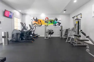 a gym with treadmills and machines in a room at The Yacht Club at Aventura Miami 4405 in Aventura