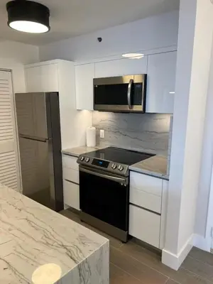 a kitchen with a stove and a microwave at The Yacht Club at Aventura Miami 4405 in Aventura