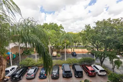 a bunch of cars parked in a parking lot at The Yacht Club at Aventura Miami 4405 in Aventura