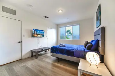 a bedroom with a bed and a table and a window at Miami Townhouse Stay with Free Parking in Miami