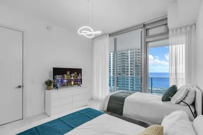 a bedroom with two beds and a view of the ocean at Chic OceanView 2 Bedroom with Free Parking Pool Jacuzzi in Sunny Isles Beach