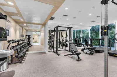a fitness room with several treadmills and machines at Chic OceanView 2 Bedroom with Free Parking Pool Jacuzzi in Sunny Isles Beach