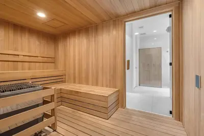 a sauna with wooden walls and a glass door at Chic OceanView 2 Bedroom with Free Parking Pool Jacuzzi in Sunny Isles Beach