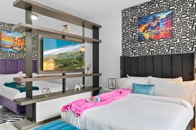 a bedroom with two beds and a tv at Luxxe Suite Downtown Brickell in Miami