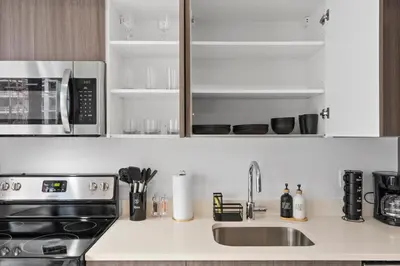 a kitchen counter with a sink and a microwave at Luxxe Suite Downtown Brickell in Miami