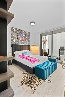 a bedroom with a large bed and a leopard rug at Luxxe Suite Downtown Brickell in Miami