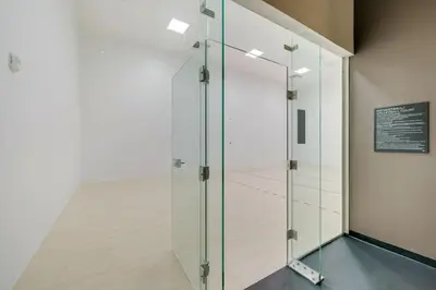 a glass shower in a room with a wall at Sleek Escape-Resort-Style Stay with Pool Spa & more in Miami