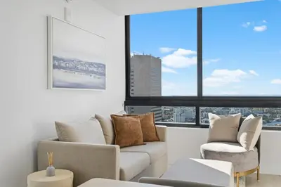 a living room with a couch and two chairs at Well-Located Condo with Free Parking and Amenities in Miami