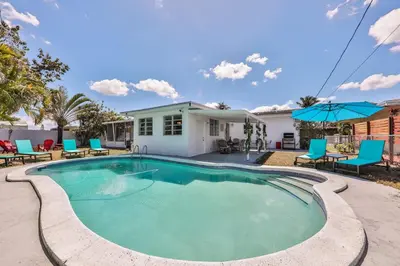 a swimming pool in front of a house at Aventura Ives Family Home in Miami