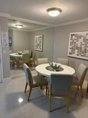 a dining room with chairs and a table and a mirror at The Yacht Club at Aventura Miami 3405 in South Island