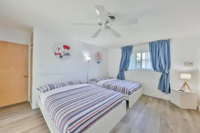 a bedroom with two beds and a ceiling fan at Family Grand Advantage in Hollywood