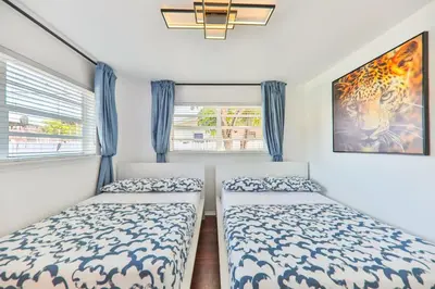 a bedroom with two beds and a window at Oasis of Love and Joy Family in Miami